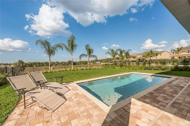 view of swimming pool with a lawn and a patio