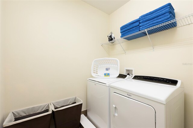 clothes washing area featuring separate washer and dryer