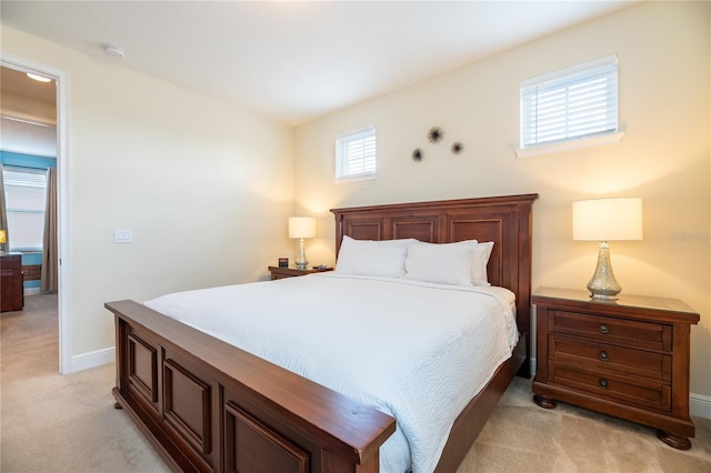 carpeted bedroom featuring multiple windows