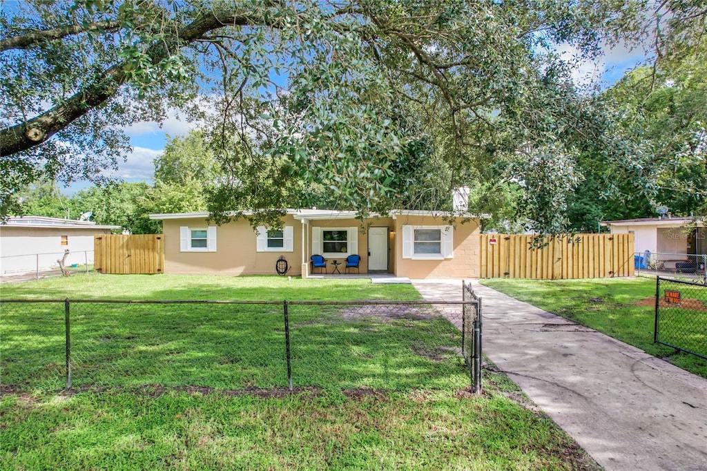 ranch-style home featuring a front lawn