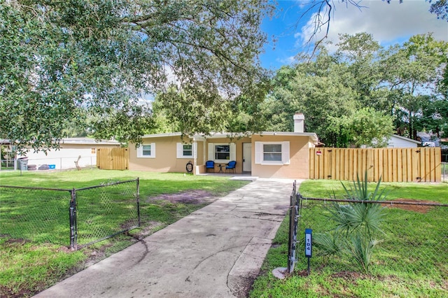 ranch-style home featuring a front yard