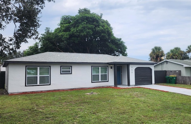 single story home featuring a garage and a front yard