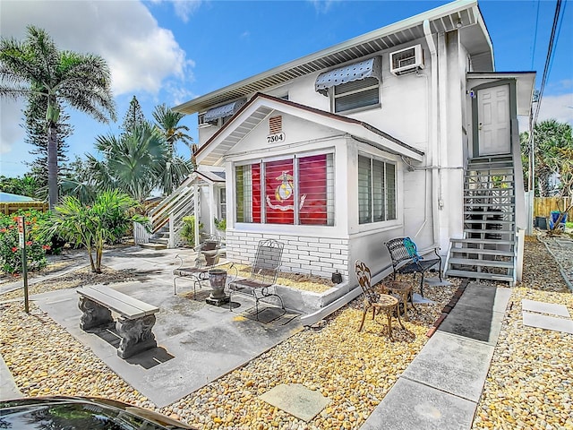 rear view of property featuring a patio