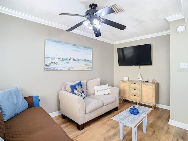 living room featuring ornamental molding, wood-type flooring, and ceiling fan