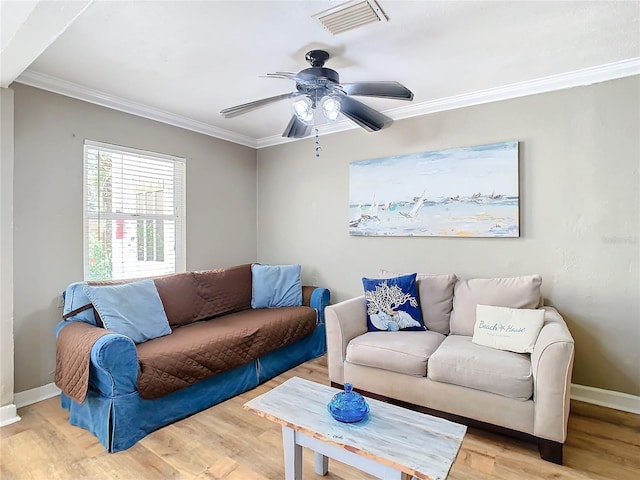 living room with ornamental molding, ceiling fan, and light hardwood / wood-style flooring