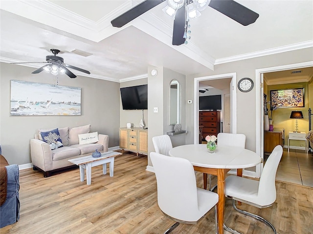 dining area featuring ceiling fan, light wood-type flooring, and crown molding