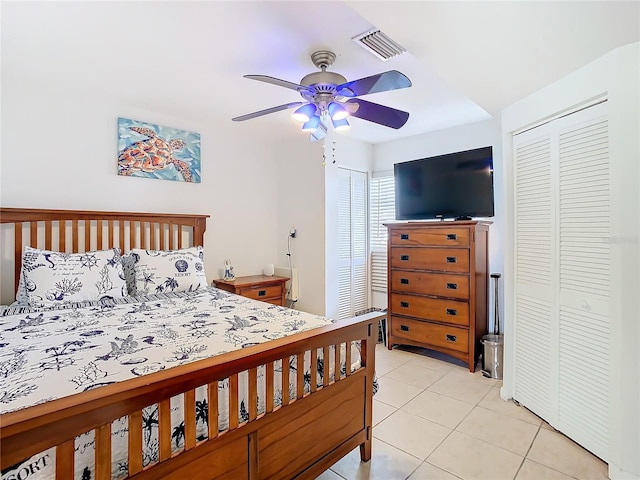 bedroom with ceiling fan and light tile patterned flooring