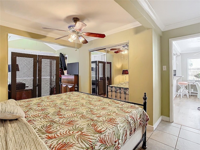 tiled bedroom featuring ceiling fan, a closet, and ornamental molding