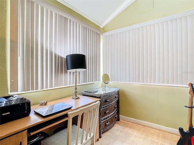 home office with ornamental molding, light hardwood / wood-style floors, and vaulted ceiling