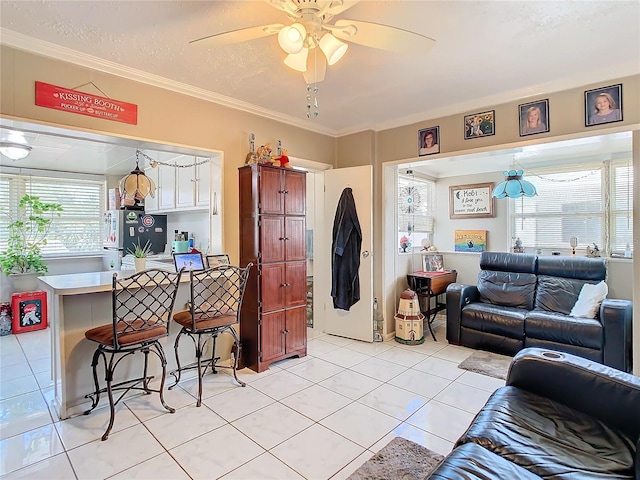 living room featuring ceiling fan, plenty of natural light, and light tile patterned floors