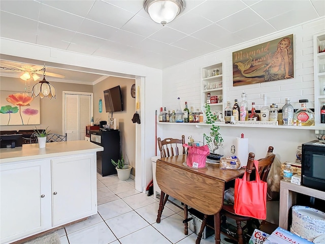 dining area featuring ornamental molding and light tile patterned floors