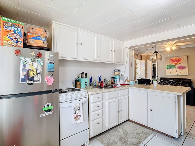 kitchen featuring white cabinets, stainless steel refrigerator, kitchen peninsula, white range, and ceiling fan