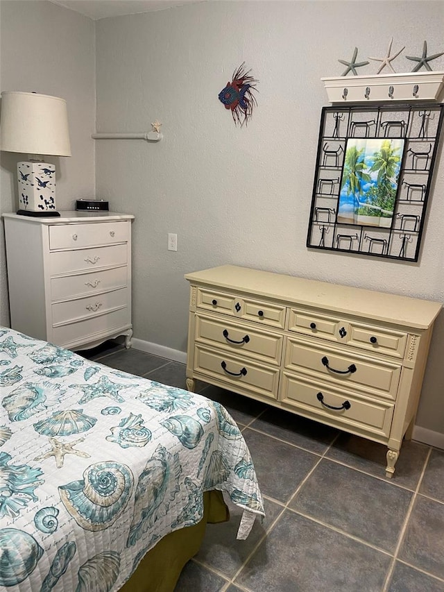 bedroom with dark tile patterned floors