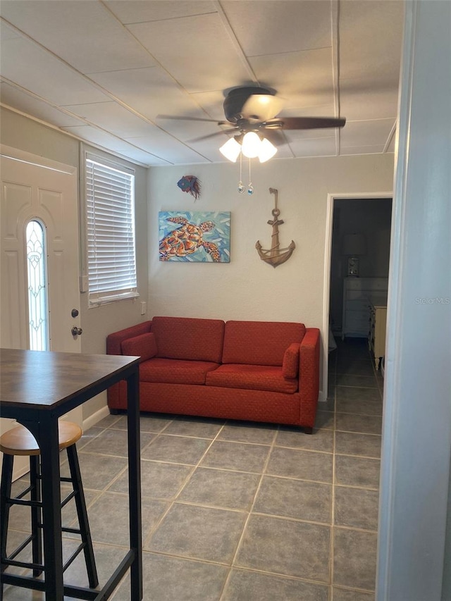 tiled living room featuring ceiling fan