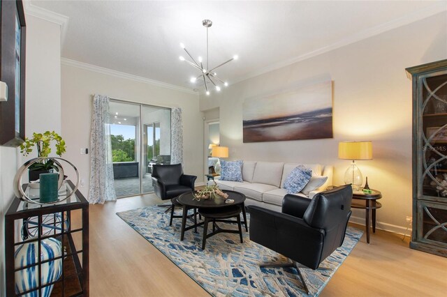 living room featuring ornamental molding, an inviting chandelier, and light hardwood / wood-style flooring