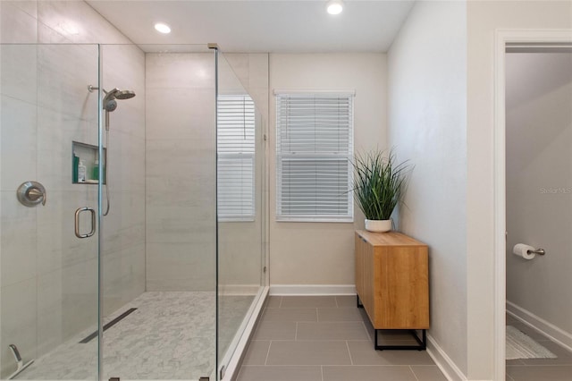 bathroom with tile patterned flooring and a shower with shower door