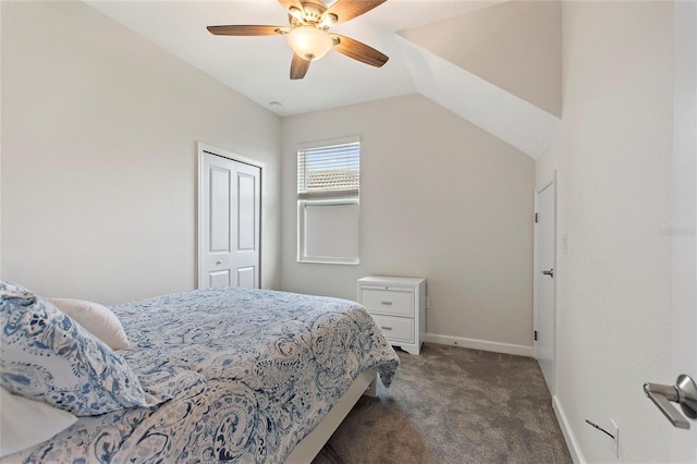 bedroom featuring vaulted ceiling, dark colored carpet, ceiling fan, and a closet