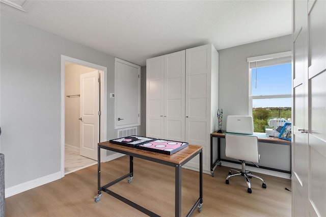 home office with light wood-type flooring