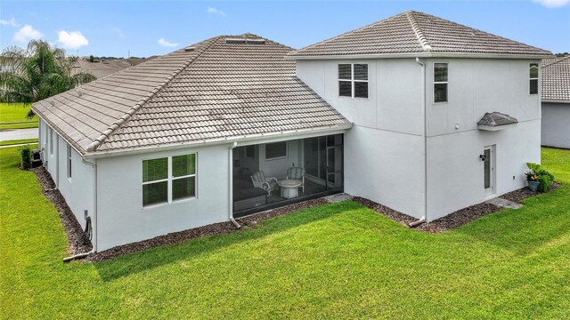 rear view of house with a yard