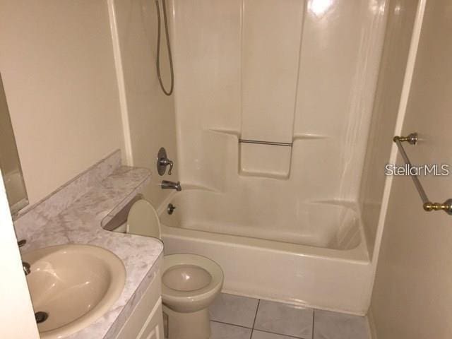 full bathroom with tile patterned floors, vanity, shower / bath combination, and toilet