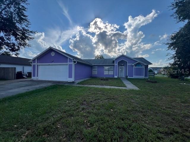 single story home with a garage and a front yard