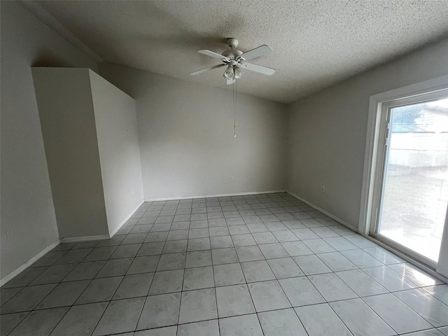 tiled spare room with a textured ceiling, vaulted ceiling, and ceiling fan