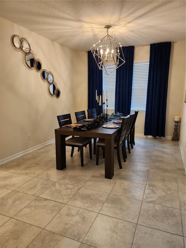 dining room featuring an inviting chandelier and a textured ceiling