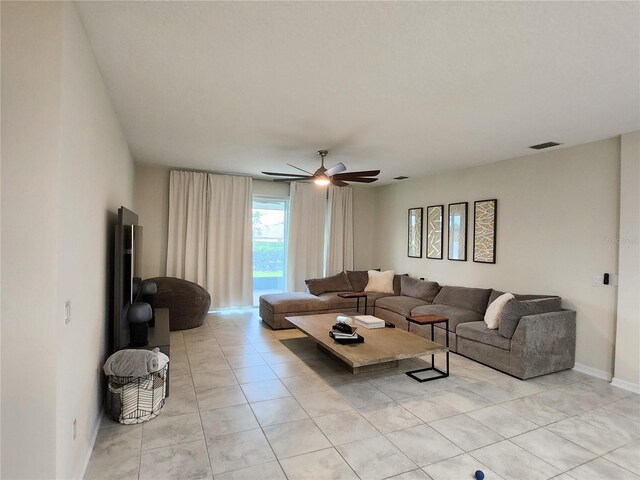 living room featuring ceiling fan and light tile patterned floors