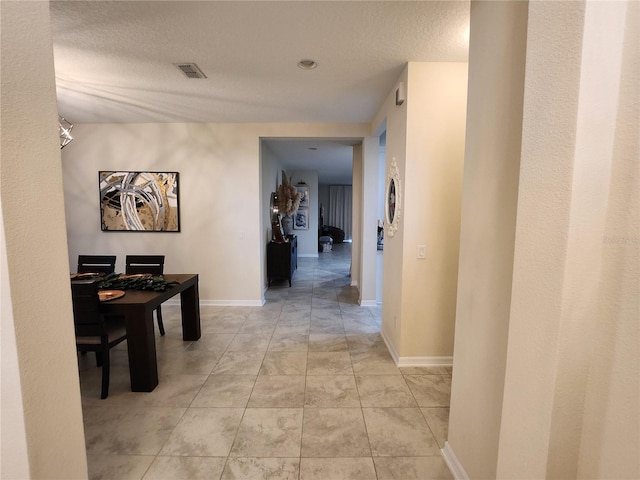 hallway featuring a textured ceiling