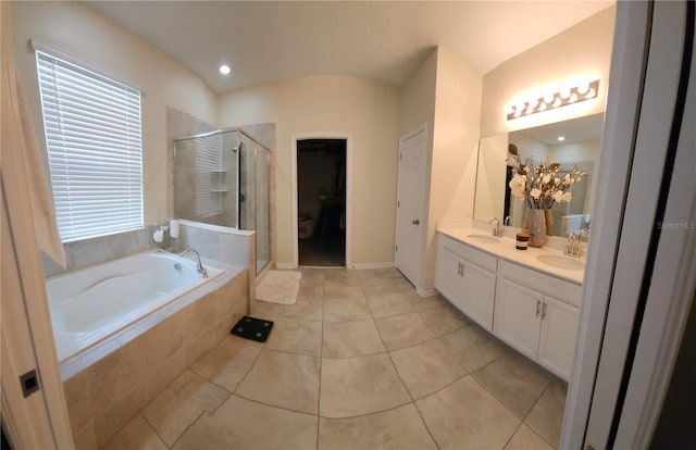 bathroom with plus walk in shower, tile patterned floors, and vanity