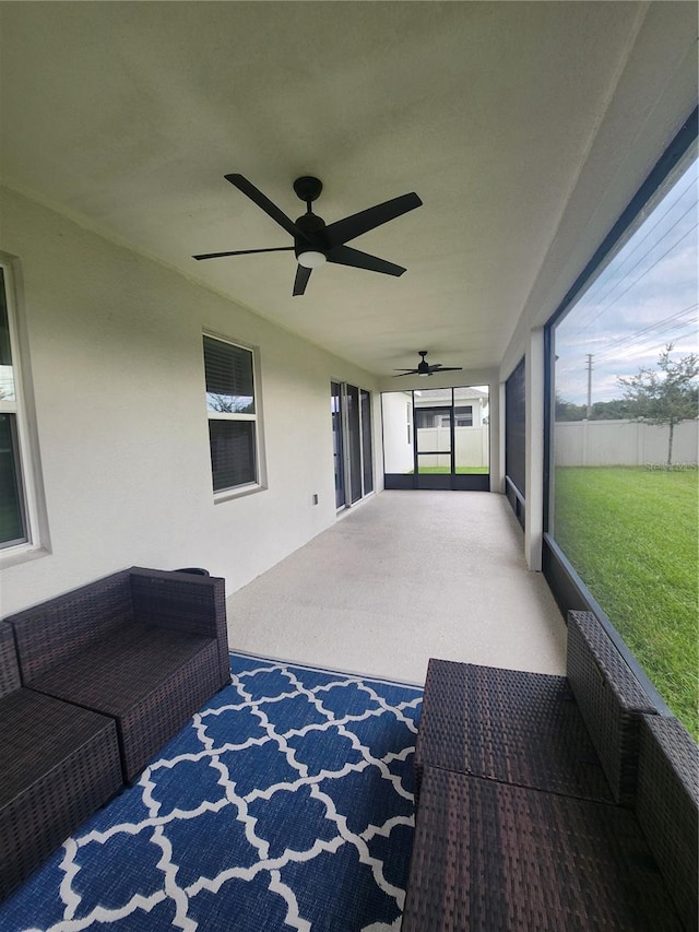 sunroom / solarium featuring ceiling fan