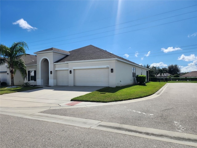 view of front of home with a garage and a front lawn