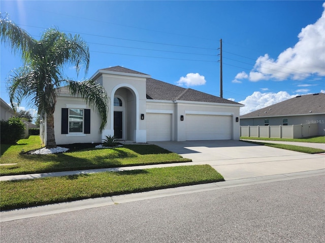 view of front of house with a front yard and a garage