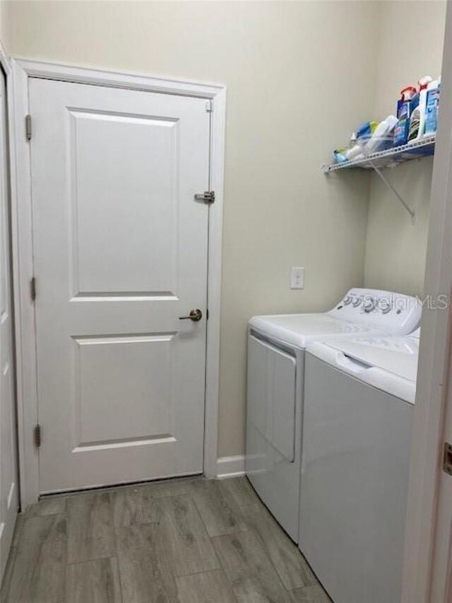 washroom featuring light hardwood / wood-style flooring and washer and dryer