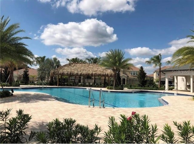 pool featuring a patio area and fence