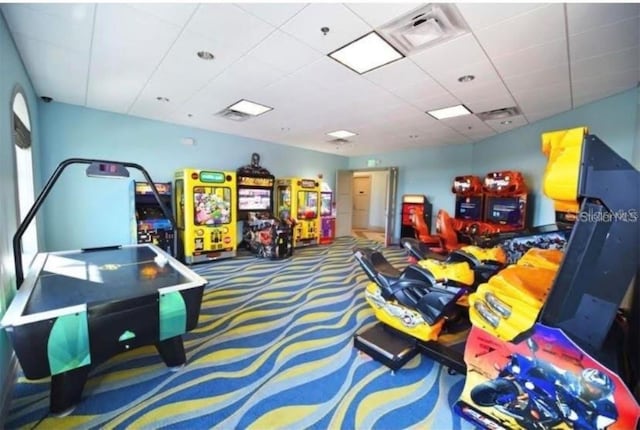 game room featuring visible vents, a paneled ceiling, and carpet