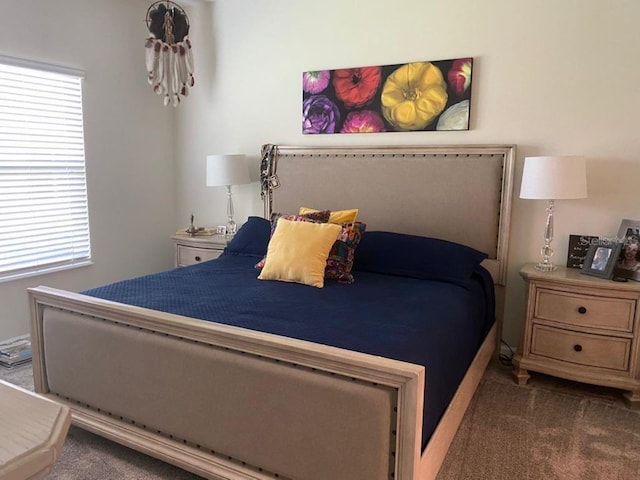 bedroom with multiple windows and dark carpet