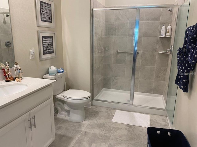 bathroom featuring tile patterned flooring, an enclosed shower, vanity, and toilet