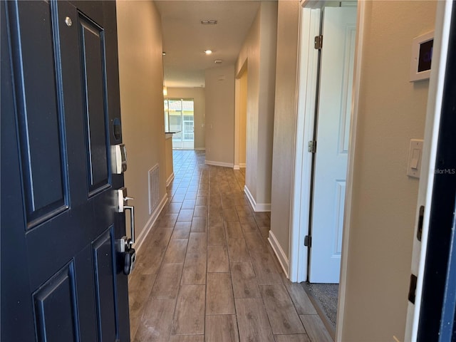 1077 Quaker Ridge Ln, Davenport, FL 33896 - corridor with baseboards, wood finished floors, visible vents, and recessed lighting