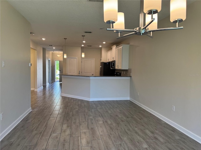 1077 Quaker Ridge Ln, Davenport, FL 33896 - kitchen featuring dark countertops, black appliances, baseboards, white cabinetry, and dark wood-style floors