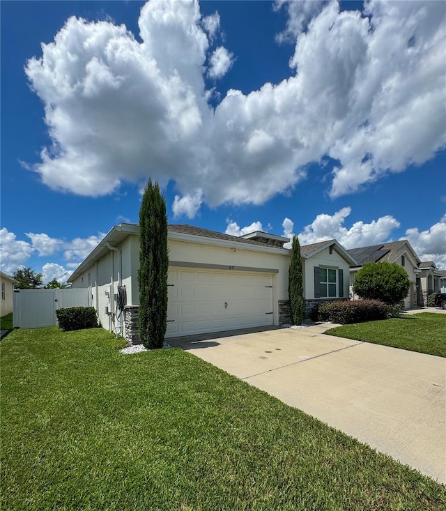 single story home with a garage and a front lawn