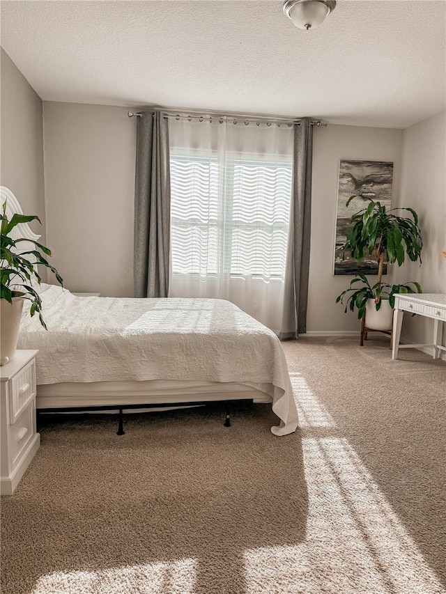 carpeted bedroom featuring a textured ceiling