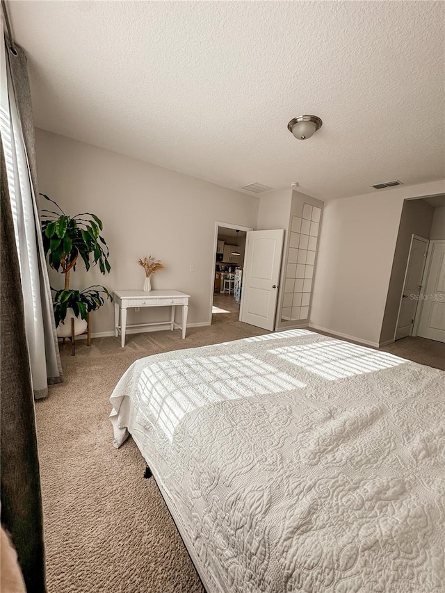 carpeted bedroom featuring a textured ceiling