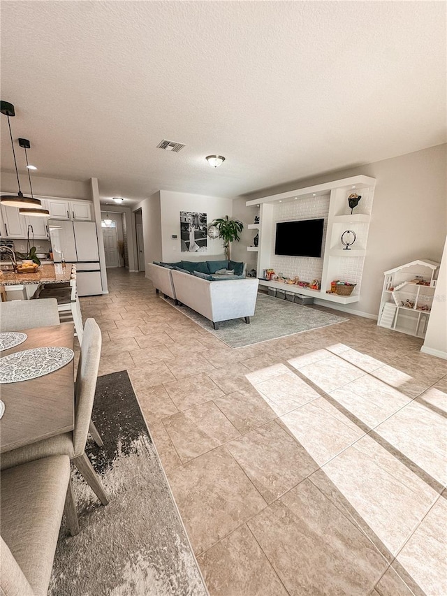 tiled living room with a textured ceiling