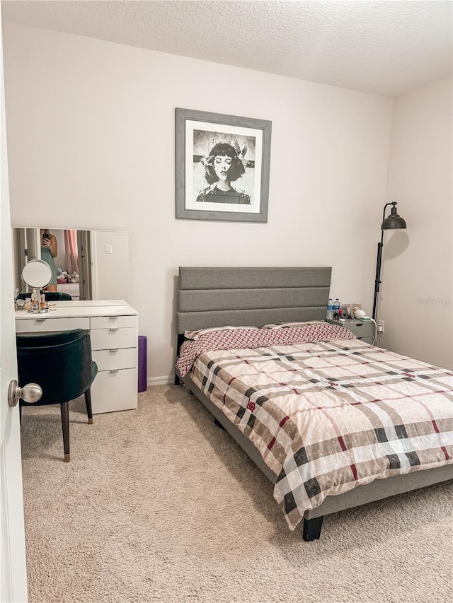 carpeted bedroom featuring a textured ceiling