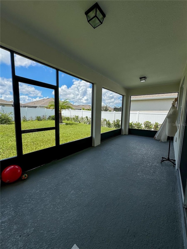 unfurnished sunroom with a water view