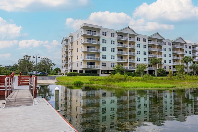 dock area with a balcony and a water view