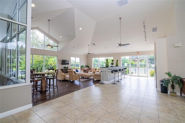 4177 N Orange Blossom Trl Unit 210, Orlando, FL 32804 - living area with ceiling fan, light tile patterned floors, high vaulted ceiling, baseboards, and rail lighting