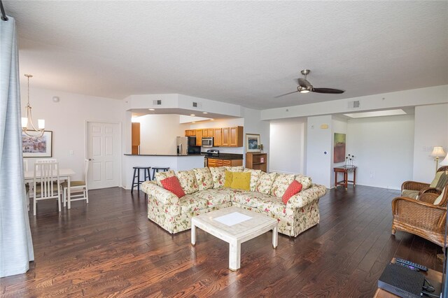 4177 N Orange Blossom Trl Unit 210, Orlando, FL 32804 - living area with dark wood-style flooring, a ceiling fan, and a textured ceiling