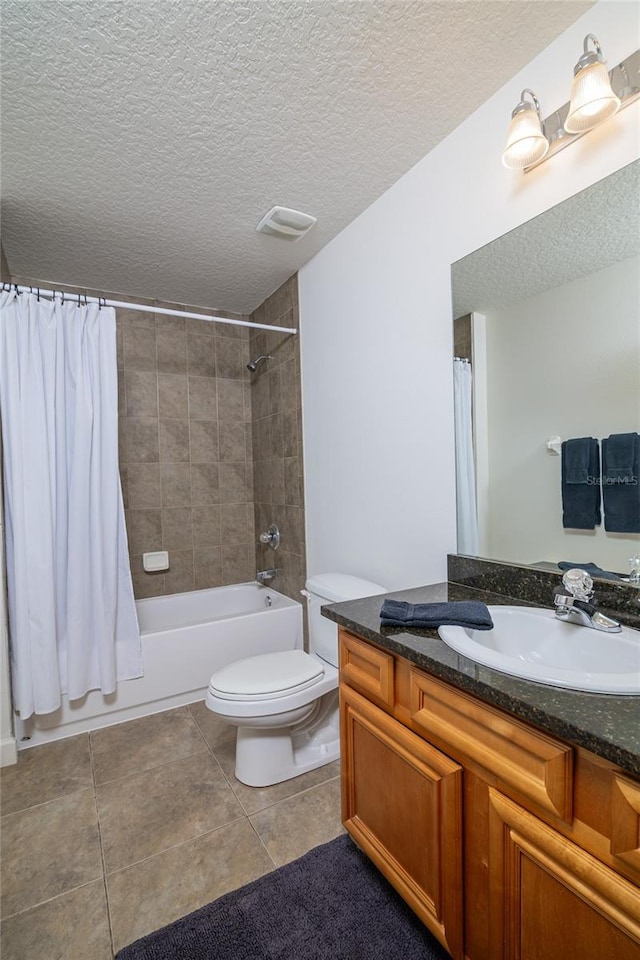 full bathroom with shower / bath combination with curtain, a textured ceiling, tile patterned floors, vanity, and toilet